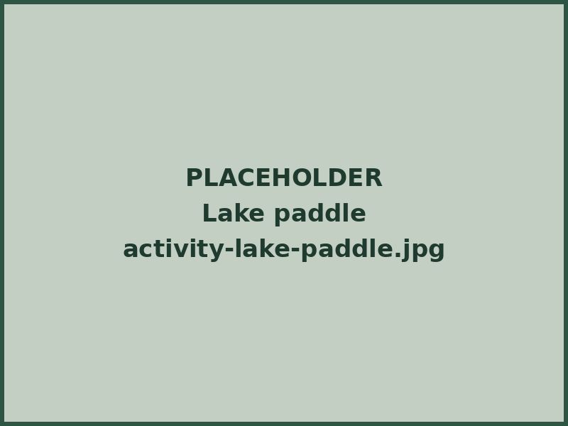 A parent and child paddling a kayak on a calm lake