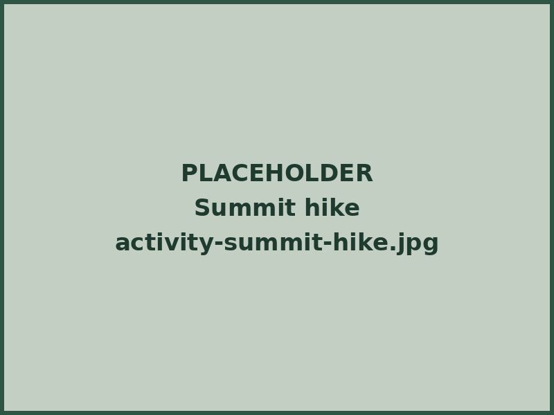 A hiker climbing a steep rocky section near a summit
